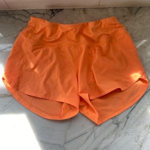 Lululemon Speed Up Mid-Rise Lined Short 4" in Orange